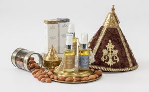 argan oil bottles with argan seeds and packaging around