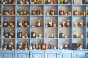 medicinal plants & herbs in different jars on shelves