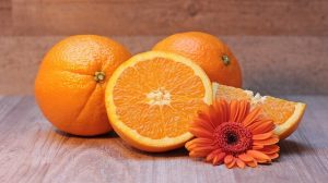 Orange sliced in half with an orange flower